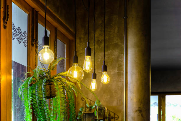 istock Yellow light of lamp hang on ceiling with copy space background 1305427044