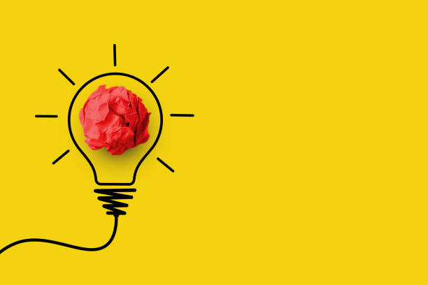 istock Creative thinking ideas and innovation concept. Paper scrap ball red colours with light bulb symbol on yellow background 1305427853