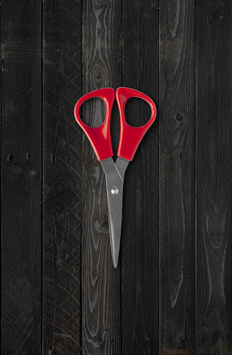 Pair of scissors mockup isolated on black wood background