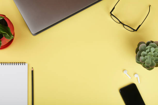 istock workspace with notebook, mobile phone, computer, green plant, coffee and eyeglass. Business background.Flat lay,top view.copy space 1305433194