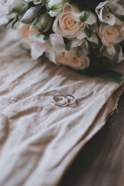 istock Wedding rings close-up on a white cloth. Wedding decorations. 1305433345
