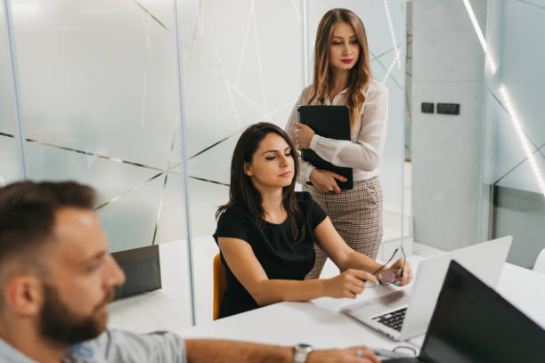 istock Manager supervising the work of the employees 1305433529
