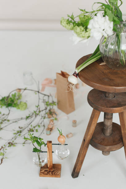 istock fresh flowers on a wooden table. White background. Green plants 1305433569