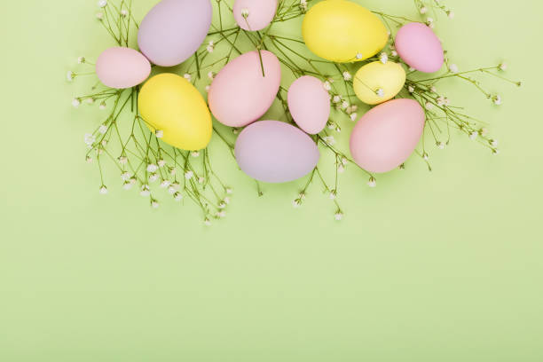 istock Stylish background with colorful easter eggs pastel colors isolated on green background. Flat lay, top view, mockup, overhead, template 1305433585