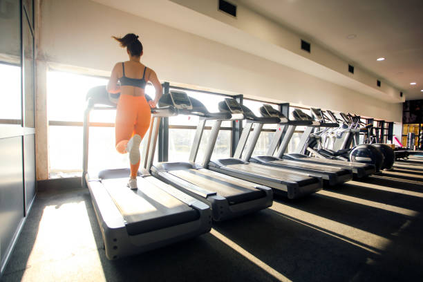 istock Young woman running on a treadmill 1305433854