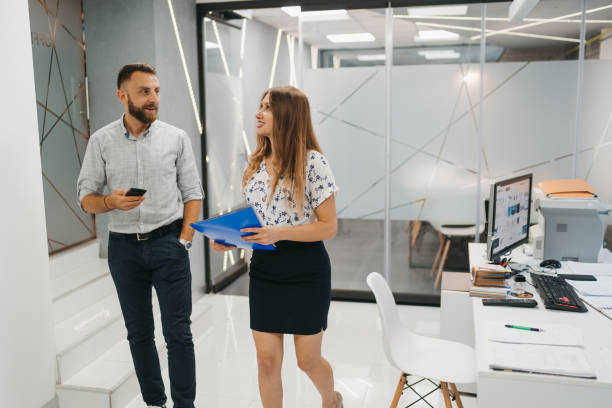 istock Business colleagues arriving to the office and chatting before work 1305434437