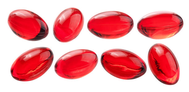 赤いカプセルのセット。白い背景に隔離 - vitamin pill red pill capsule ストックフォトと画像
