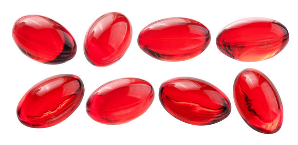 A set of red capsules. Isolated on a white background