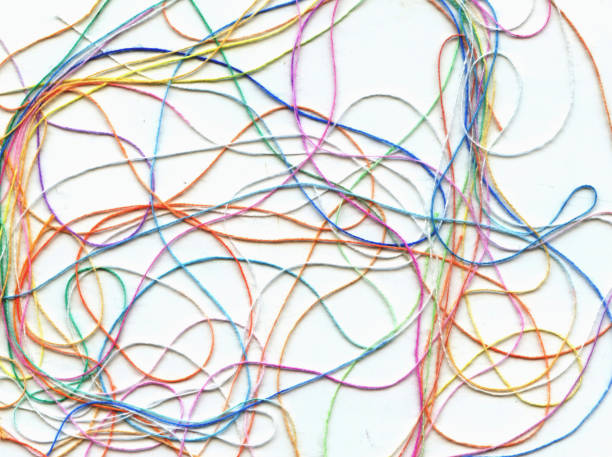 istock Multicolor tangled color needlecraft silk cord. Abstract color background, in white background 1305436997