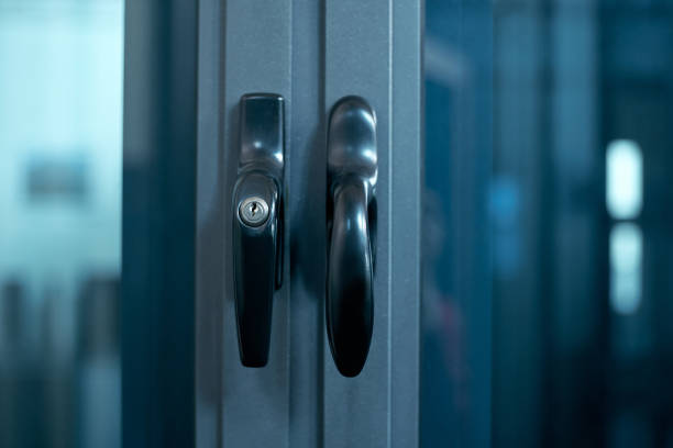 istock close-up. metal handle on the glass door. lock for window handle 1305437229