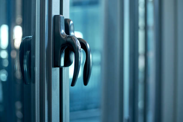 istock close-up. metal handle on the glass door. lock for window handle 1305437240