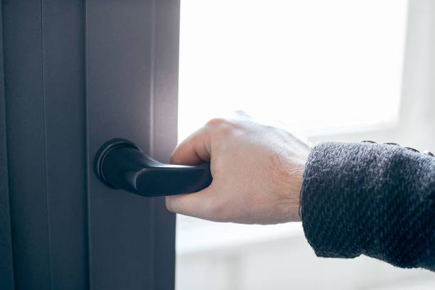 istock close-up. man opening the front door. photo with a copy-space 1305437805