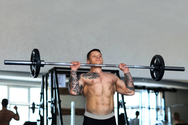 istock bodybuilder works with a barbell in the gym 1305438305