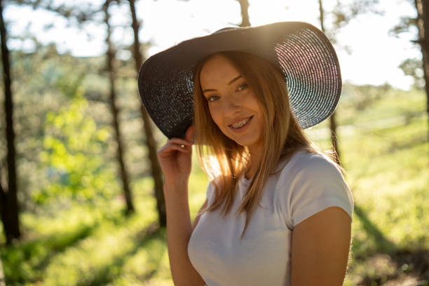 istock Smiling young woman in sunny woods 1305440848