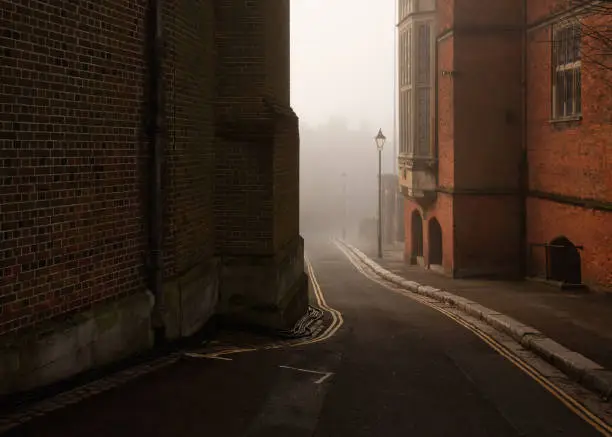 Photo of Foggy road between buildings of Harrow on the Hill in England