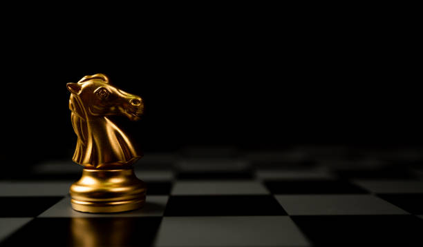 istock Golden Chess horse standing alone on the chessboard 1305443565