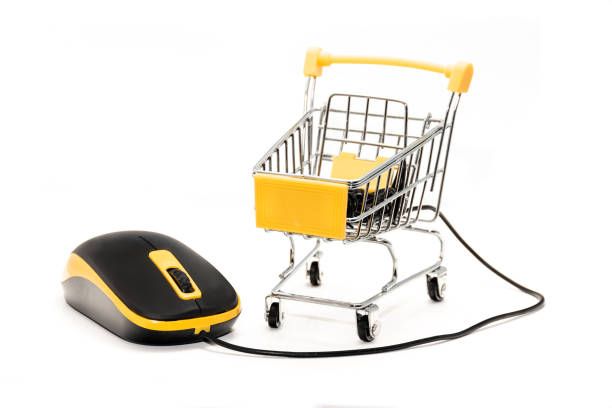 istock Internet online shopping concept with wired mouse and trolley cart 1305443589