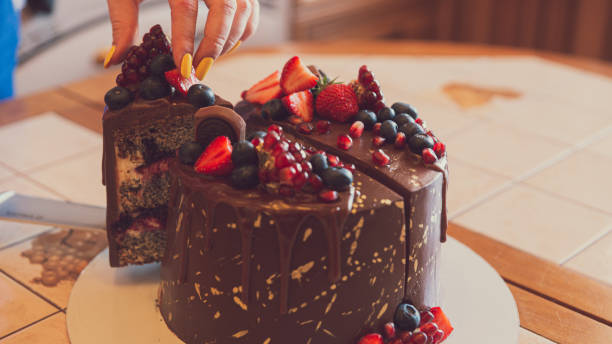 istock A chocolate cake decorated with strawberries, blueberries and a pomegranate on an orange background 1305445276