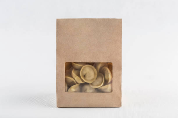 Dumplings in eco-friendly paper packaging for delivery on a white background, isolated. Dumplings in eco-friendly paper packaging for delivery on a white background, isolated. Close-up with a copy space for the text. Horizontal orientation. russian pelmeni stock pictures, royalty-free photos & images