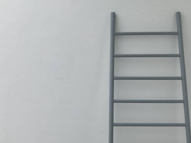 istock gray metal stair leans against white cement wall 1305445532