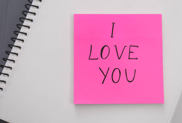 istock Memory sticker with phrase I Love You on notebook, top view. Valentine's Day celebration 1305450497