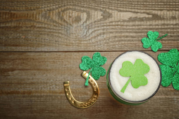 istock Beer and St Patrick's Day decor on wooden table, flat lay. Space for text 1305450560