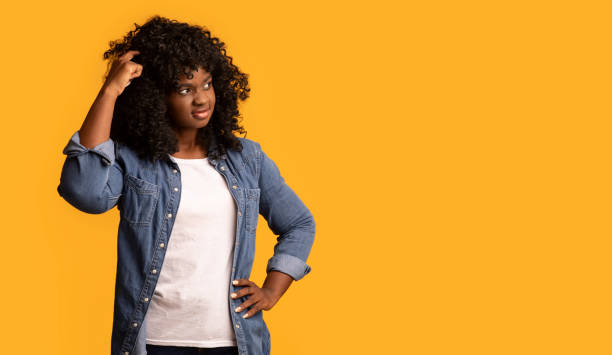 istock Curious black woman looking at copy space 1305452712