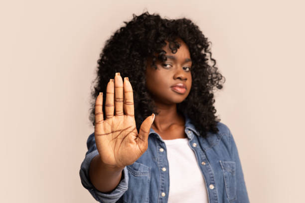 istock Black woman showing her palm, stop gesture 1305452817