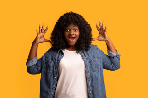 istock Ecstatic african american young woman yelling with hands up 1305453069