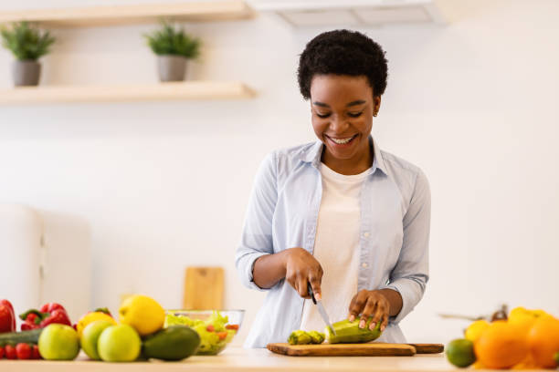 istock Happy African American Lady Cooking In Kitchen Enjoying Dinner Preparation 1305453832