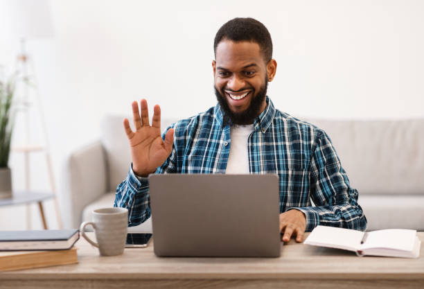 istock Black Business Guy At Laptop Video Calling Sitting In Office 1305453839