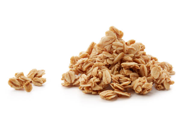 granola heap of granola isolated on white background granola photos stock pictures, royalty-free photos & images