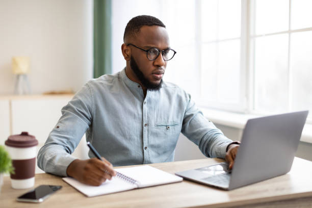 istock African Business Guy Working On Laptop Taking Notes At Workplace 1305454041