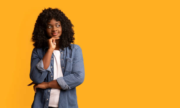 istock Excited african american young woman watching empty space and smiling 1305456552