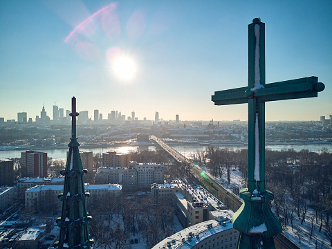 Beautiful panoramic aerial drone view of the Warsaw City Centre through two church towers with huge crosses - St. Florian Cathedral, Warsaw, Poland, EU