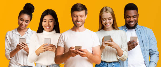 istock Five Diverse People Using Smartphones Standing Over Yellow Background, Collage 1305457807