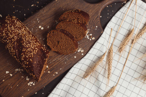 istock Sliced rye bread on cutting board. Whole grain rye bread with seeds 1305460005