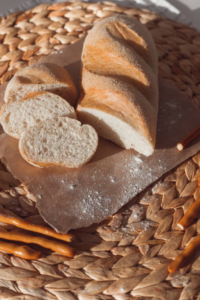 istock Ciabatta bread with ears of wheat 1305460055