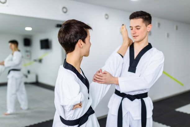istock Disabled woman training taekwondo with her coach. 1305460570