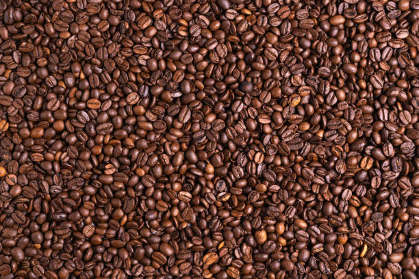 istock Roasted black coffee beans background. Top view, backdrop 1305461562