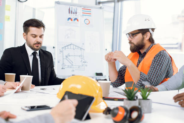 istock Team of construction designers planning project at office 1305462582