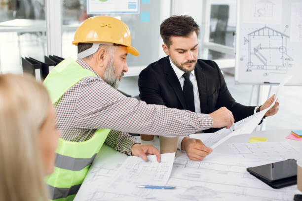 istock Engineers and architects discussing plan of new building 1305462607
