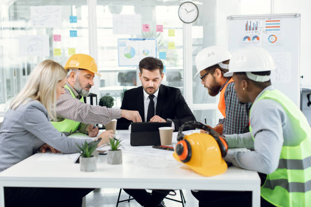 istock Diverse group of architects and engineers working at office 1305462677