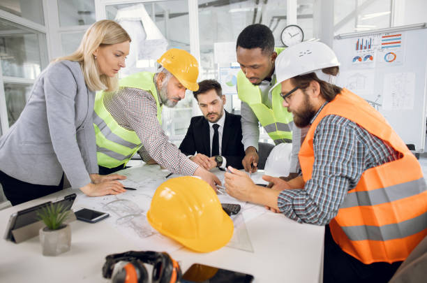 istock Business partners planning construction project at office 1305462898