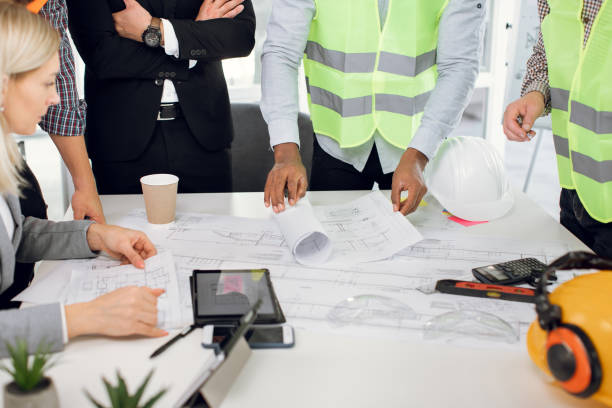 istock Close up of five multiracial people working with drawings 1305462926