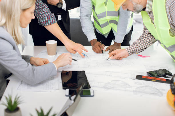 istock Close up of five multiracial people working with drawings 1305462935
