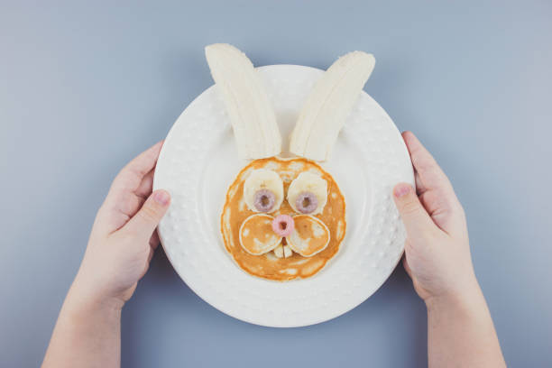 istock Funny Easter bunny pancakes, breakfast for a child. Pancake with banana. 1305463020