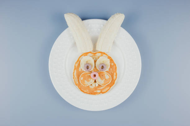 Funny Easter bunny pancakes, breakfast for a child. Pancake with banana. Funny Easter bunny pancakes, breakfast for a child. Pancake with banana. bunny pancake stock pictures, royalty-free photos & images