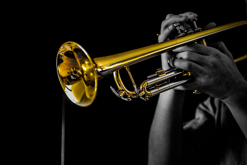 Trumpet player shot in photo studio, colored B&W style