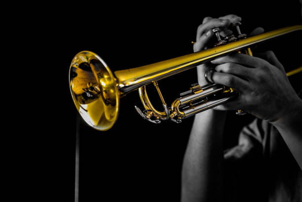 Trumpet player Trumpet player shot in photo studio, colored B&W style man trumpet stock pictures, royalty-free photos & images